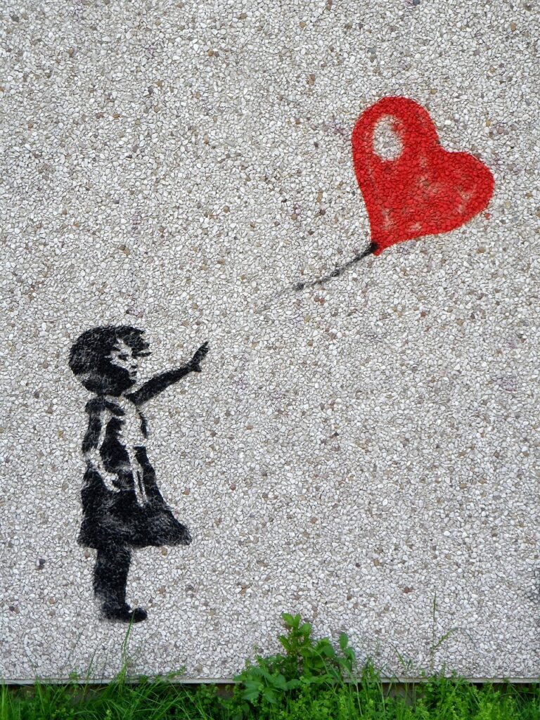 Girl reaches for red heart balloon in art by Banksy.